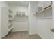 This walk-in closet provides ample storage space with shelving units and overhead storage at 27629 N 176Th Dr, Surprise, AZ 85387