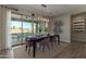 Elegant dining area with modern lighting and a view to the outdoor patio at 27629 N 176Th Dr, Surprise, AZ 85387