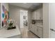 Hallway featuring stylish flooring, modern lighting, and entry to kitchen at 27629 N 176Th Dr, Surprise, AZ 85387