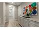 Hallway featuring stylish flooring, modern lighting, and colorful artwork at 27629 N 176Th Dr, Surprise, AZ 85387