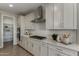 A well-lit kitchen features white cabinets, a stylish backsplash, and stainless steel appliances at 27629 N 176Th Dr, Surprise, AZ 85387