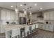 Bright, modern kitchen with stainless steel appliances, a spacious island, and stylish pendant lighting at 27629 N 176Th Dr, Surprise, AZ 85387