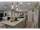 Bright, modern kitchen with a spacious island, stainless steel appliances, and pendant lighting at 27629 N 176Th Dr, Surprise, AZ 85387