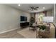 Cozy living space featuring a sectional sofa, contemporary furnishings, and a ceiling fan at 27629 N 176Th Dr, Surprise, AZ 85387