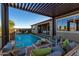 Inviting backyard pool and patio area with comfortable outdoor seating and dining space at 27629 N 176Th Dr, Surprise, AZ 85387