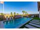 Inviting backyard pool featuring a waterfall feature and comfortable lounge chairs at 27629 N 176Th Dr, Surprise, AZ 85387