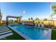 Backyard pool with waterfall feature, lounging area and decorative stone walkway at 27629 N 176Th Dr, Surprise, AZ 85387