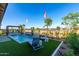 Inviting pool area with waterfall feature, lounging area, and desert landscaping at 27629 N 176Th Dr, Surprise, AZ 85387