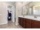 Bathroom with dual sinks, vanity, and walk-in closet featuring ample storage space at 2831 W Carson Rd, Phoenix, AZ 85041