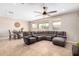 Inviting living area with tile flooring, a ceiling fan, comfortable seating, and a dining area at 2831 W Carson Rd, Phoenix, AZ 85041