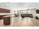 Open concept living space with tile flooring, a dining area, and a comfortable sectional sofa at 2831 W Carson Rd, Phoenix, AZ 85041