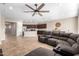 Spacious living area with tile floors, a ceiling fan, and a sectional sofa at 2831 W Carson Rd, Phoenix, AZ 85041