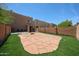 Large backyard with pavers, turf, and block wall is great for outdoor activities and privacy at 2912 E Eberle Ln, Phoenix, AZ 85032