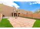 Spacious backyard with decorative stone patio, artificial grass, and brick wall at 2912 E Eberle Ln, Phoenix, AZ 85032