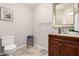 Powder room features elegant mirror, cabinet, hardware and lighting at 2912 E Eberle Ln, Phoenix, AZ 85032