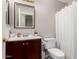 Bathroom with shower and sink features a dark cabinet with gold hardware at 2912 E Eberle Ln, Phoenix, AZ 85032
