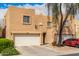 Charming townhome featuring a two-car garage, desert landscaping, and a private entrance for curb appeal at 2912 E Eberle Ln, Phoenix, AZ 85032