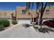 Home exterior features a 2-car garage and desert-style landscaping in a community of attached homes at 2912 E Eberle Ln, Phoenix, AZ 85032