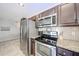 Well-equipped kitchen features stainless steel appliances and stylish granite countertops at 2912 E Eberle Ln, Phoenix, AZ 85032