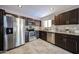 Bright kitchen boasts stainless steel appliances and beautiful granite countertops and dark cabinets at 2912 E Eberle Ln, Phoenix, AZ 85032