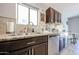 Stylish kitchen showcases granite countertops, stainless steel dishwasher, and dark wooden cabinets at 2912 E Eberle Ln, Phoenix, AZ 85032