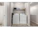 Laundry room with washer, dryer, and overhead storage shelves at 2912 E Eberle Ln, Phoenix, AZ 85032