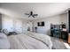 Spacious main bedroom featuring plush carpet, ceiling fan and bright windows at 2912 E Eberle Ln, Phoenix, AZ 85032