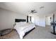 Spacious main bedroom featuring plush carpet, ceiling fan and bright windows at 2912 E Eberle Ln, Phoenix, AZ 85032