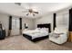 Spacious main bedroom with carpet, ceiling fan, windows, and a luxury bed frame at 2912 E Eberle Ln, Phoenix, AZ 85032