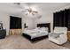 Carpeted main bedroom with ceiling fan, windows, and a luxury bed frame at 2912 E Eberle Ln, Phoenix, AZ 85032