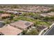Wide aerial shot features a home with solar panels and backyard pool in a neighborhood with green space at 29854 N 132Nd Dr, Peoria, AZ 85383