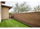 A cozy backyard features artificial grass and a sturdy brick wall for privacy and aesthetic appeal at 29854 N 132Nd Dr, Peoria, AZ 85383