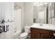 Bright bathroom features a shower-tub combination and single sink vanity with storage at 29854 N 132Nd Dr, Peoria, AZ 85383