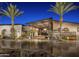 The Mita Club boasts modern architecture, open-air design, and inviting ambiance with palm trees and brick pavement at 29854 N 132Nd Dr, Peoria, AZ 85383
