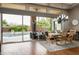 Charming dining room with a wooden table, chandelier, and sliding glass doors to the beautiful outdoor pool area at 29854 N 132Nd Dr, Peoria, AZ 85383