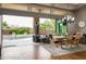 Charming dining room with a wooden table, chandelier, and sliding glass doors to the beautiful outdoor pool area at 29854 N 132Nd Dr, Peoria, AZ 85383