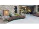 The Kiva Club is a beautiful entrance with stone accents and vibrant flowering plants at 29854 N 132Nd Dr, Peoria, AZ 85383