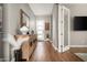 Bright entryway with wood floors, gray walls, modern decor, and a view of the front door at 29854 N 132Nd Dr, Peoria, AZ 85383