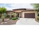 Beautiful single-story home with a curved driveway, desert landscaping, and a two-car garage at 29854 N 132Nd Dr, Peoria, AZ 85383