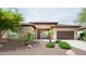 Inviting single-story home featuring a desert landscaped yard and a two-car garage at 29854 N 132Nd Dr, Peoria, AZ 85383