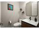Stylish half bath featuring a floating vanity, modern fixtures, elegant mirror, and charming decor at 29854 N 132Nd Dr, Peoria, AZ 85383