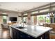 Open-concept kitchen with marble countertops, modern appliances, and view of the living area at 29854 N 132Nd Dr, Peoria, AZ 85383