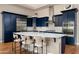 Modern kitchen with navy blue cabinets, stainless steel appliances, and a large center island at 29854 N 132Nd Dr, Peoria, AZ 85383