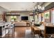 Spacious living and dining area featuring hardwood floors, large windows, and stylish decor at 29854 N 132Nd Dr, Peoria, AZ 85383