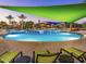 Resort-style pool area with inviting blue water, comfortable lounge chairs, and shaded canopies for relaxation at 29854 N 132Nd Dr, Peoria, AZ 85383