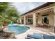 Backyard pool and spa area has covered outdoor seating, built-in kitchen and beautiful landscaping at 29854 N 132Nd Dr, Peoria, AZ 85383