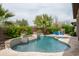 Backyard pool and spa are surrounded by travertine patio, lush landscaping, and privacy walls at 29854 N 132Nd Dr, Peoria, AZ 85383