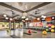 The workout area features spin bikes, weights, fitness balls, overhead fans and modern lighting at 29854 N 132Nd Dr, Peoria, AZ 85383
