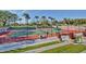 Enjoy a game of tennis at the community courts with well-maintained green and red surfaces and surrounding palm trees at 29854 N 132Nd Dr, Peoria, AZ 85383