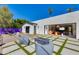 Modern backyard features an outdoor seating area, gravel, pavers, grass, and desert landscaping at 3117 E Campbell Ave, Phoenix, AZ 85016
